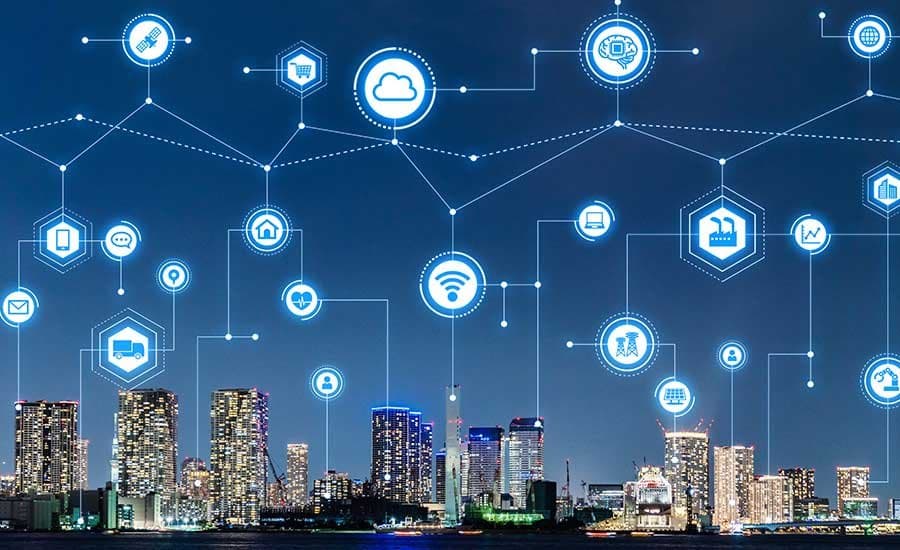 A city skyline at night overlaid with connected-building icons
