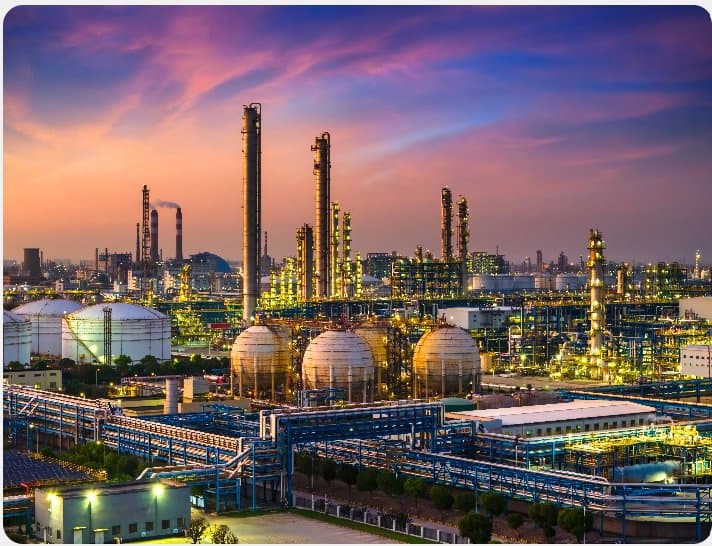 A petrochemical refinery with storage spheres at dusk
